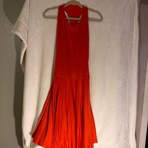 Orange dress. it stylizes the figure, marking the waist and abdomen